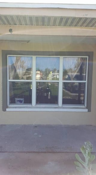 Three new windows with the surrounding stucco finished and matched to the old wall
