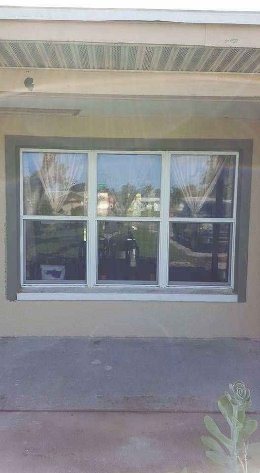 Three new windows with the surrounding stucco finished and matched to the old wall