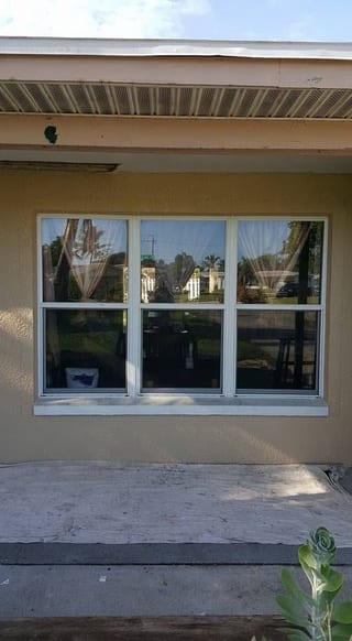 New windows set into the wall with the stucco band still being worked around them