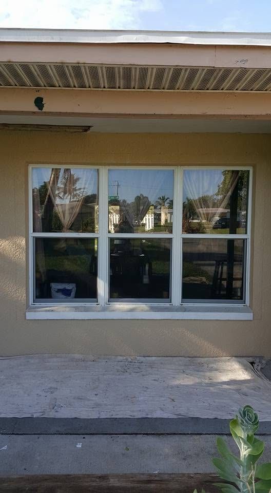 New windows set into the wall with the stucco band still being worked around them