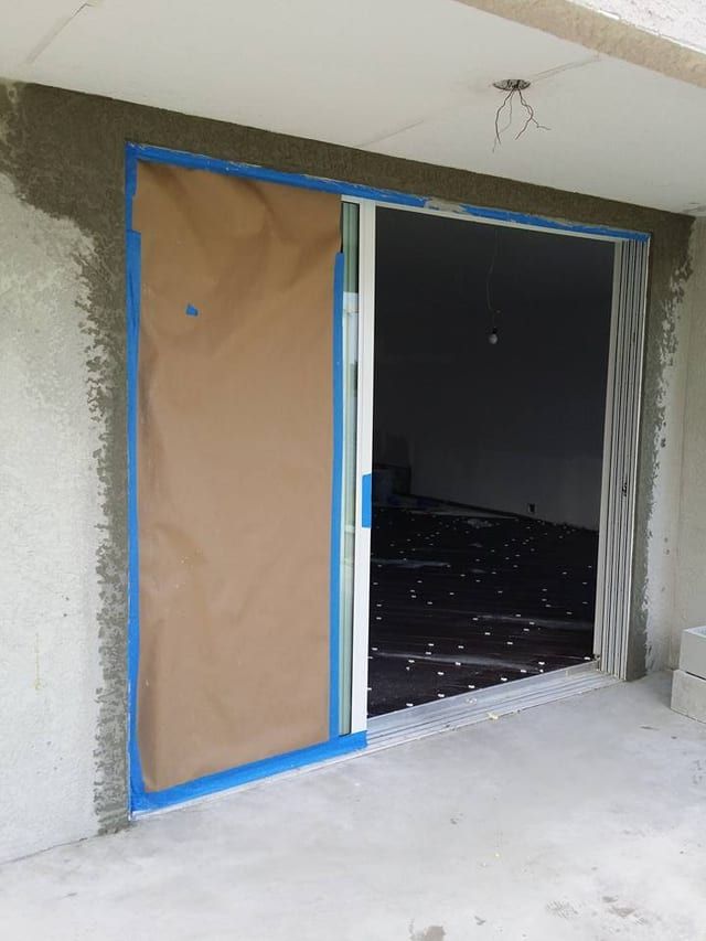 Same sliding door with the surround masked off and a fresh scratch coat applied