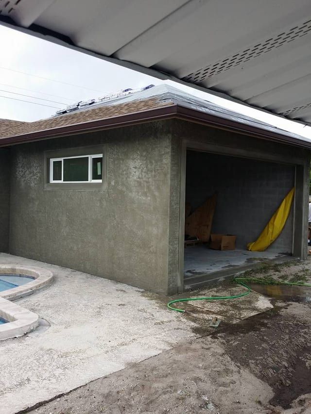 The same addition mid-job with the stucco coat on and the window installed