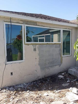 Lakeside wall with new windows and exposed block below ready for stucco