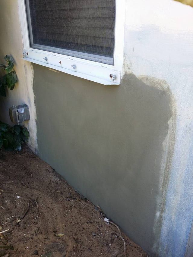Same window after fresh stucco patch under the sill