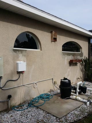 Pool-equipment wall with rust-stained water damage before repair